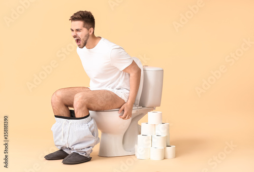 Screaming man sitting on to...