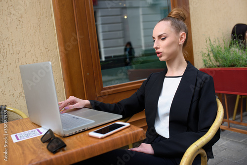 Young woman working on her laptop typing rext photo