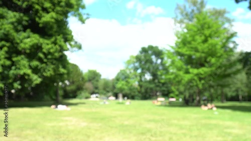 Blurred background of Family kid enjoy fun play in the park and Friend hangout plays sport with social distancing in summer during coronavirus new normal