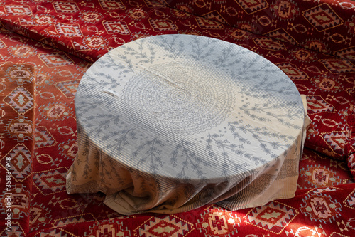 Old style table, floor table with oriental rag in Turkey photo