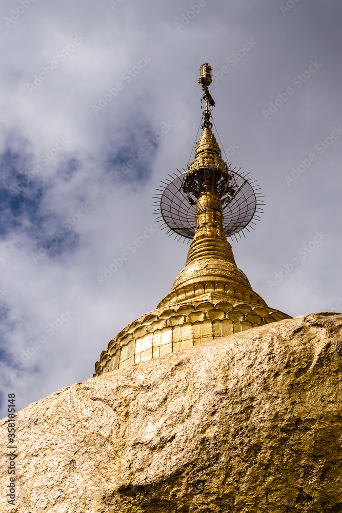 Gilded stupa on top of the Golden Rock temple at Mt. Kyaiktiyo, Myanmar. Kyaiktiyo Pagoda is one of the most famous buddhist pilgrimage sites in Myanmar.