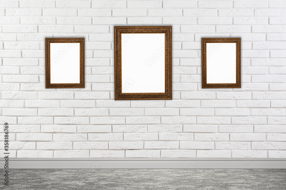 Frames with empty canvases on brick wall in modern art gallery. Space for design Frames with empty canvases on brick wall in modern art gallery. Space for design