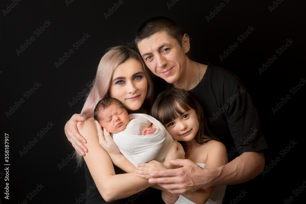 family portrait. a mother with a newborn child and an older sister with a father. mom dad and kids family portrait. a mother with a newborn child and an older sister with a father. mom dad and kids