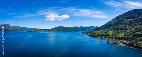 aerial image of the entrance to glencoe, ballachulish and loch leven from loch linnhe on the west coast of the argyll and lochaber region of the highlands of scotland on a clear blue sky summer day © Andy Morehouse