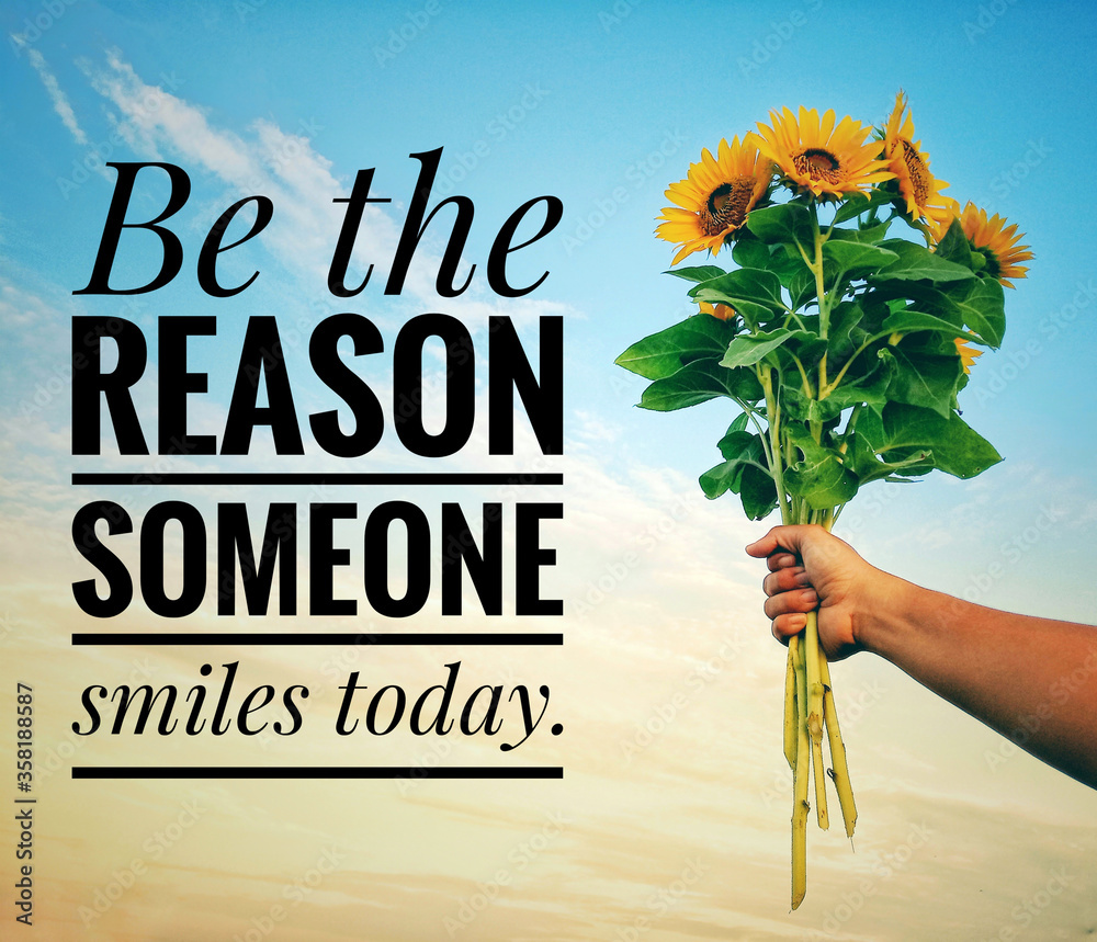 Inspirational quote - Be the reason someone smiles today. With a hand holding a bunch of sunflowers against bright blue sky background. Motivational text message with flowers and sky background. - obrazy, fototapety, plakaty 