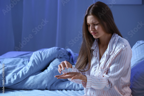Young woman taking sleeping...