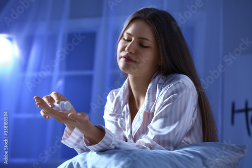 Young woman taking sleeping...