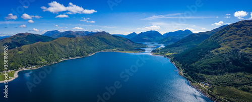 aerial image of the entrance to glencoe, ballachulish and loch leven from loch linnhe on the west coast of the argyll and lochaber region of the highlands of scotland on a clear blue sky summer day