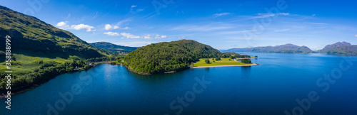 aerial image of loch linnhe on the west coast of the argyll and lochaber region of scotland near kentallen and duror showing calm blue waters and clear skies with green forest coast line