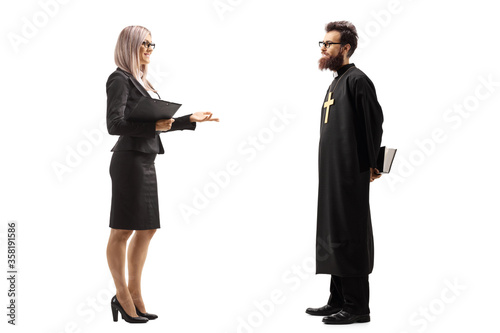 Businesswoman standing and talking to a catholic priest