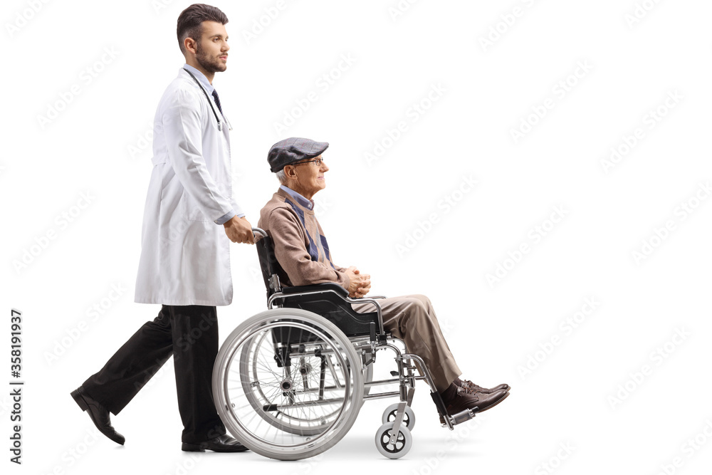 Young male doctor pushing a disabled elderly patient in a wheelchair Young male doctor pushing a disabled elderly patient in a wheelchair