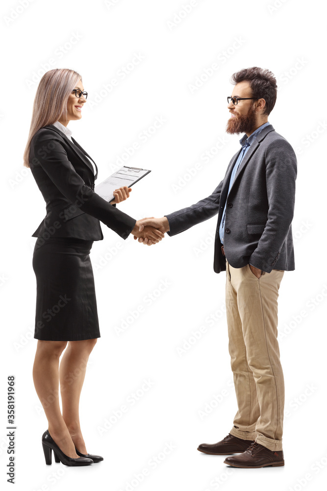 Businesswoman shaking hands with a bearded man