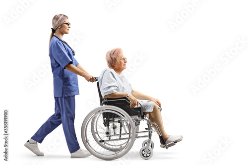 Female nurse pushing an elderly patient in a wheelchair