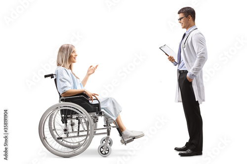 Young female patient in a wheelchair talking to male doctor