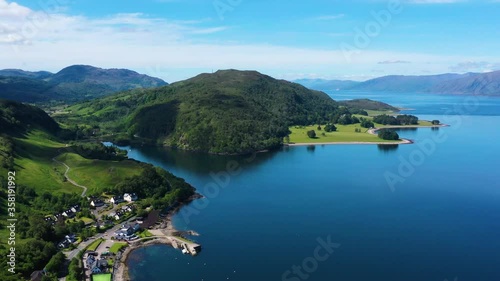 aerial footage of loch linnhe on the west coast of the argyll and lochaber region of the highlands of scotland on a clear blue sky summer day with calm waters and green forest coast line