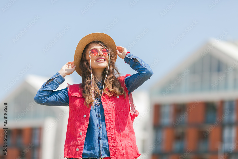 young woman with straw hat enjoying sunny day outdoors