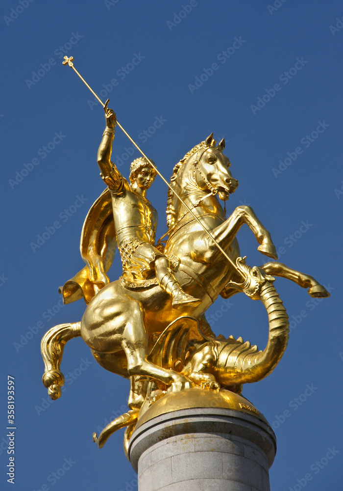 Gold sculpture of St. George slaying a dragon atop a column in Freedom Square, Tbilisi, Georgia