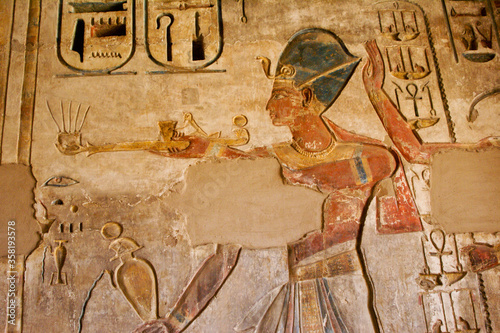 Painted reliefs inside room at Medinat Habu Temple, Luxor, Egypt photo