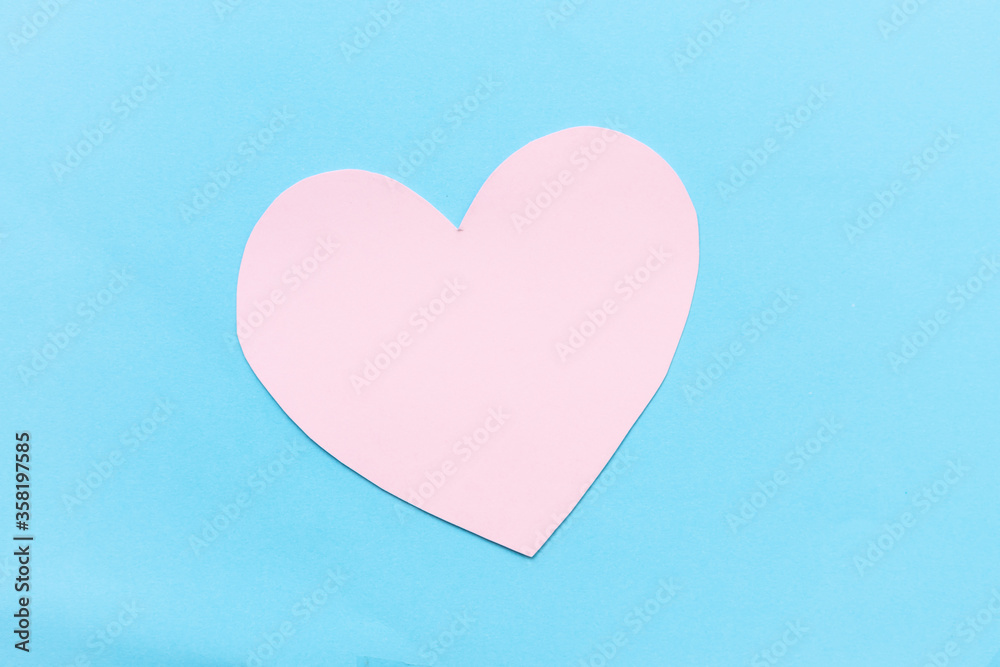 Pink Paper Heart Beat shape on blue background.