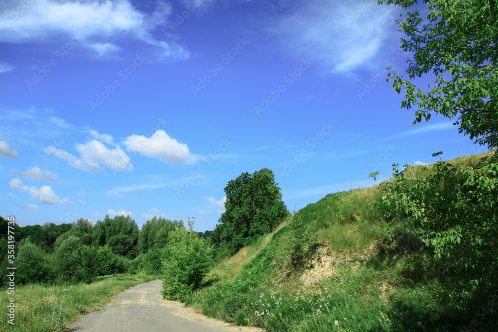Road in the village among beautiful nature. Landscape in the summer. Stock photo background Road in the village among beautiful nature. Landscape in the summer. Stock photo background