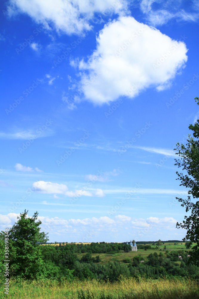 Beautiful summer landscape of nature countryside. Green vegetation of grass and trees with hills. Stock photo for design