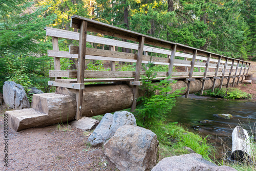 A footbridge built on a log crosses the creek in the Clear Creek Crossing Campground, Oregon, USA