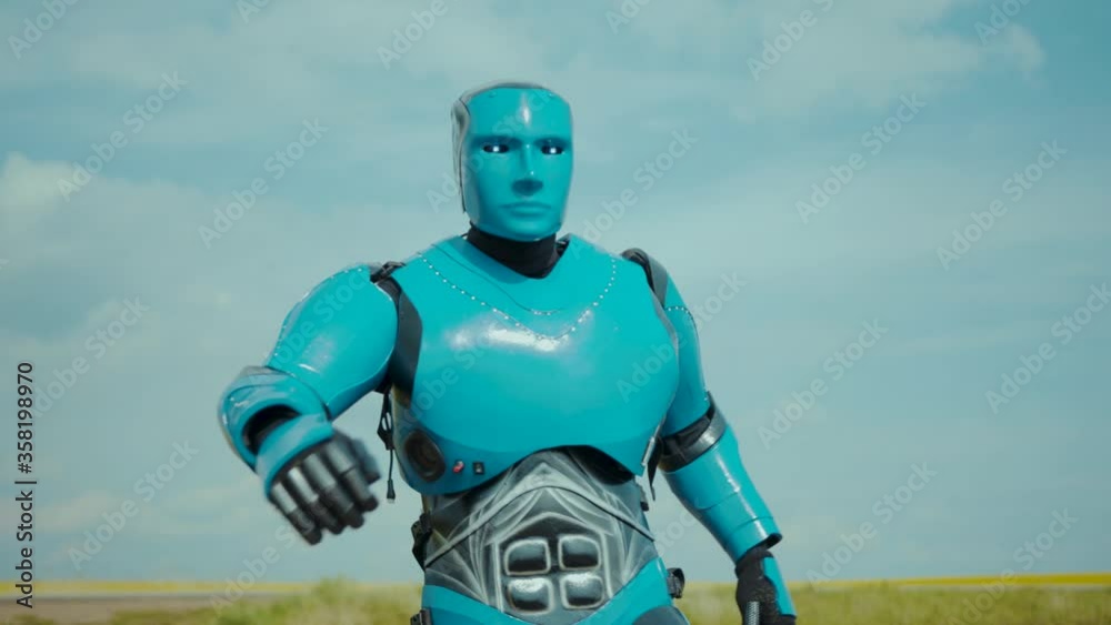 Robotic farm droid walking on rural field monitoring cultivation. Futuristic farming worker cyborg robot typing button on his body activating smart technology. AI. Agriculture. Robotic farm droid walking on rural field monitoring cultivation. Futuristic farming worker cyborg robot typing button on his body activating smart technology. AI. Agriculture.