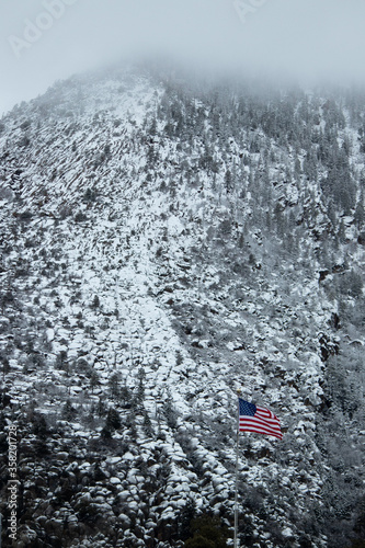american flag by snow mountains © melinda
