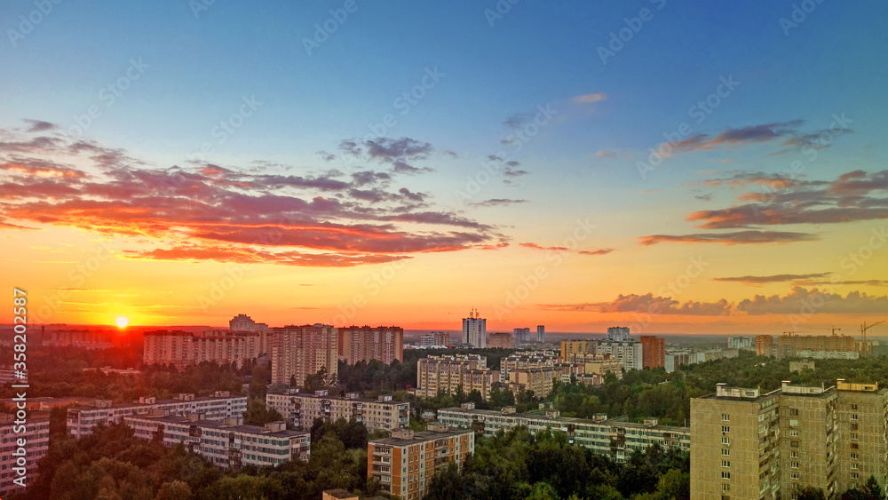 View from the city of Korolev to Moscow. The view from the height. Sunset over the city. Yarkon orange sky at the end of the day. Beautiful evening.