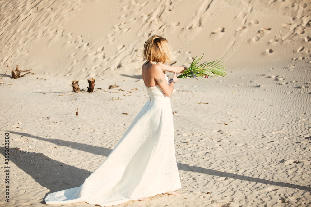 A trendy an attractive blonde bridegrooms in a beach A trendy an attractive blonde bridegrooms in a beach