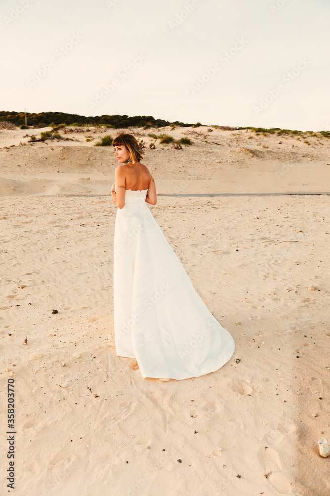 An attractive trendy blonde young bride in a beach An attractive trendy blonde young bride in a beach