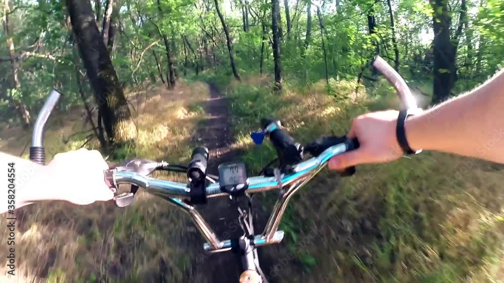 Travel. Ride a bike along a forest path. First-person cycling through the woods. Healthy lifestyle concept. Travel. Ride a bike along a forest path. First-person cycling through the woods. Healthy lifestyle concept.