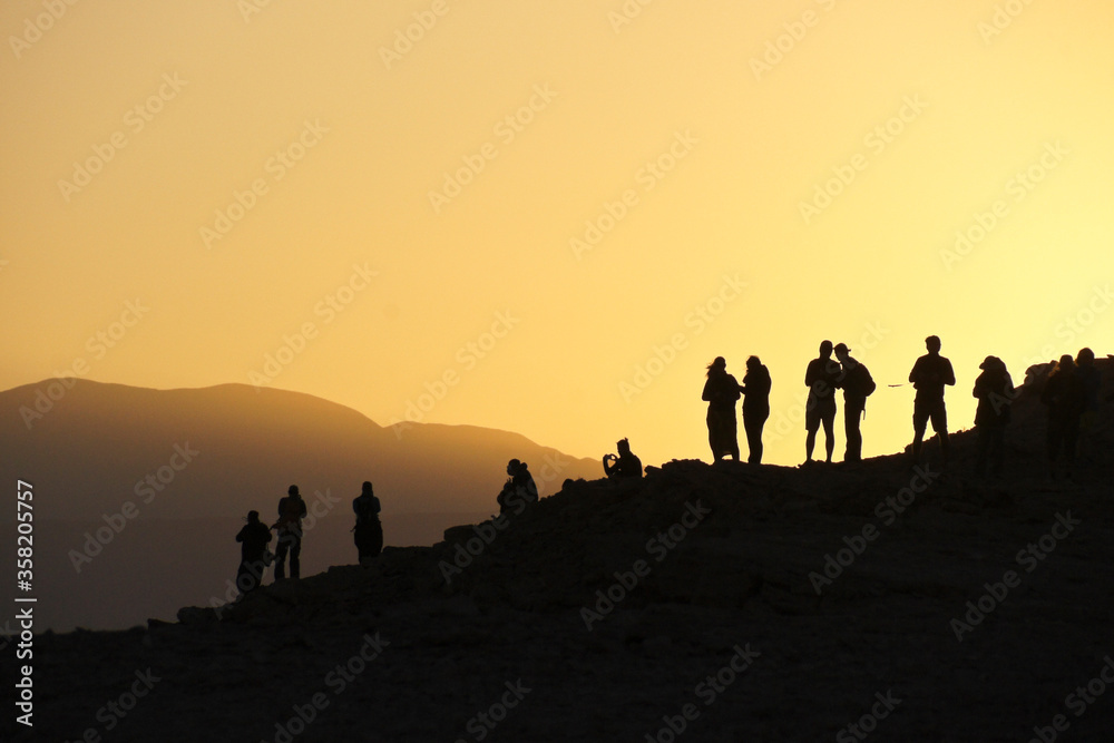 Silhouette of people viewing sunset from Mirador Coyote, above Valle de la Luna (Moon Valley), Atacama Desert, Norte Grande, Chile