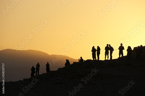 Silhouette of people viewing sunset from Mirador Coyote, above Valle de la Luna (Moon Valley), Atacama Desert, Norte Grande, Chile