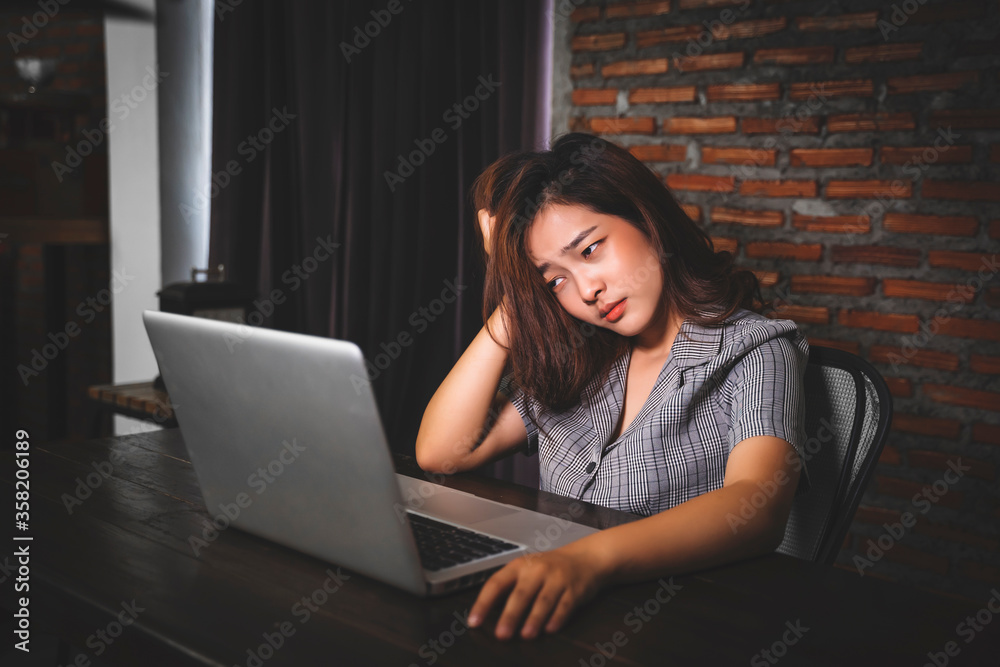 Asian businesswoman working late night tired sleepy overworked using computer laptop technology freelance business plan strategy work from home desk modern office during coronavirus COVID-19 pandemic Asian businesswoman working late night tired sleepy overworked using computer laptop technology freelance business plan strategy work from home desk modern office during coronavirus COVID-19 pandemic