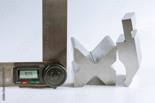 Sheet metal bending tool and equipment isolated on a white. Bend tools, press brake punch and die. Digital protractor. photo