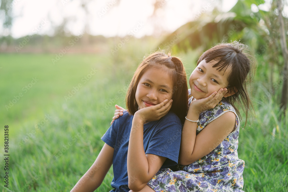 Happy little child girlfriends in green field Happy little child girlfriends in green field
