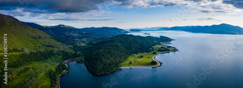 aerial image of loch linnhe on the west coast of the argyll and lochaber region of scotland near kentallen and duror showing calm blue waters and clear skies with green forest coast line photo
