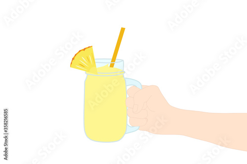 Hand is holding​ a yellow smoothie juice in a glass cup with and has pineapple slice on top. A cold soft drink for summer. Healthy beverage. Tasty and yummy food. A takeaway Product advertisement.