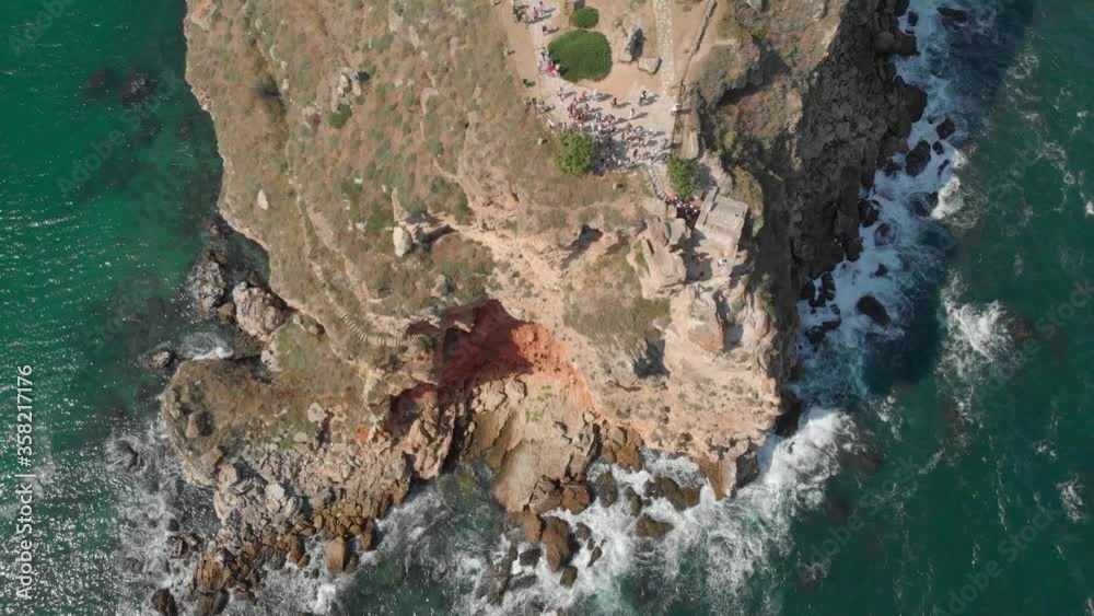 A crowd of tourists gathered by the edge of a mountain cliff in Bulgaria to enjoy the view - top view A crowd of tourists gathered by the edge of a mountain cliff in Bulgaria to enjoy the view - top view