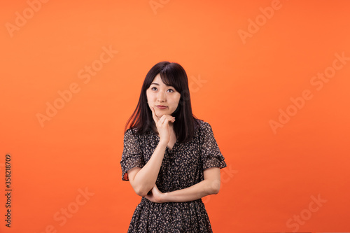 Beautiful asian woman with flowered dress isolated