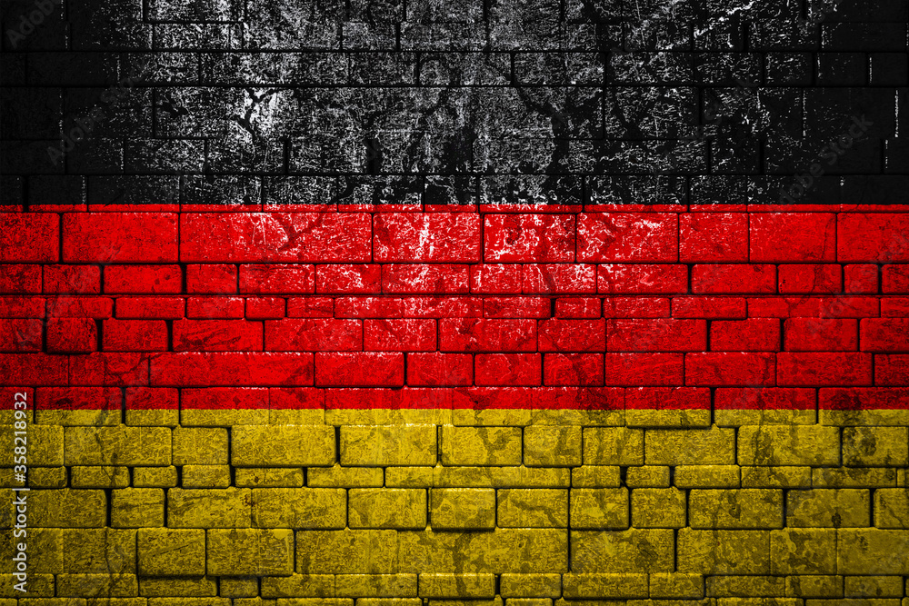 National flag of Germany on brick wall background.The concept of national pride and symbol of the country. Flag banner on stone texture background. National flag of Germany on brick wall background.The concept of national pride and symbol of the country. Flag banner on stone texture background.