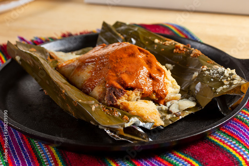A view of a tamal guatemalteco, in a restaurant or kitchen setting. photo