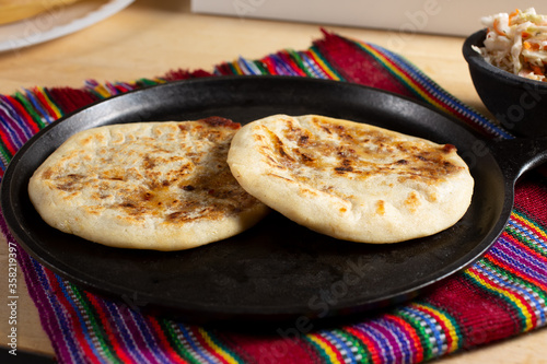 A view of pupusas on a comal, in a still life setting. photo