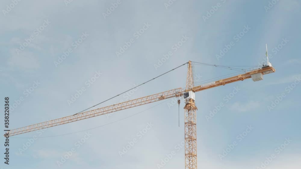 Construction Site Crane Under Summer Sky, Detail, View From Moving Vehicle Construction Site Crane Under Summer Sky, Detail, View From Moving Vehicle