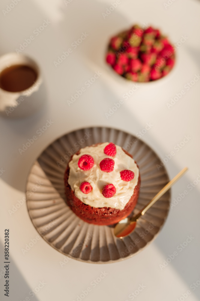 Delicious cupcakes with berries on stand over white background Delicious cupcakes with berries on stand over white background
