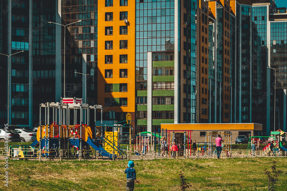 people are resting on the streets of a new modern residential area on a sunny day people are resting on the streets of a new modern residential area on a sunny day
