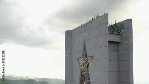 Buzludja. Dron top view on one of the largest in Europe abandoned communist monuments in the Balkan mountains, Bulgaria. UFO disc-shaped building with a red star. photo