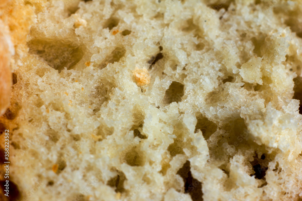 Macro photography of a slice home-baked bread. Texture or background Macro photography of a slice home-baked bread. Texture or background