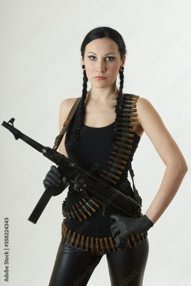 White girl dressed in black with shotgun and bullets. White girl dressed in black with shotgun and bullets.
